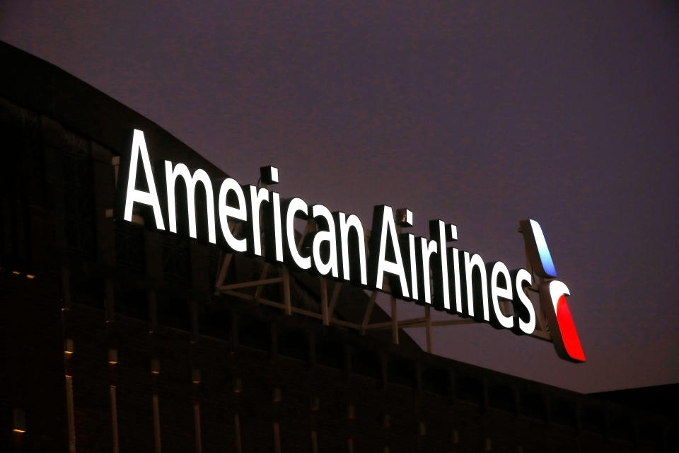 FILE- This Dec. 19, 2017, file photo shows the American Airlines logo on top of the American Airlines Center in Dallas. Police used a stun gun multiple times on an unruly American Airlines passenger before removing him from a Miami to Chicago flight on Sunday, April 22, 2018. An American Airlines statement says crew members asked the man to get off the plane after he had a "disagreement" with another passenger on Sunday night. (AP Photo/Michael Ainsworth, File)