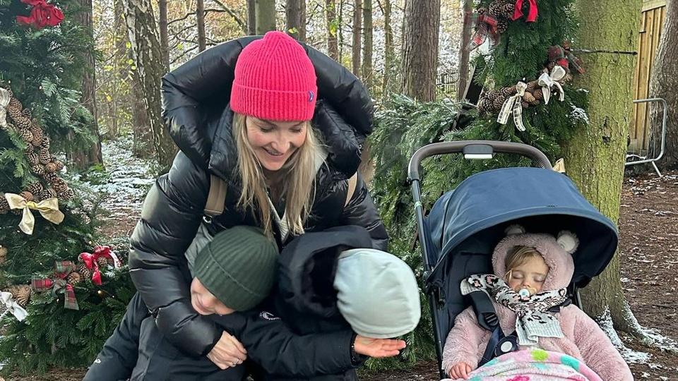 mother outside with three children 