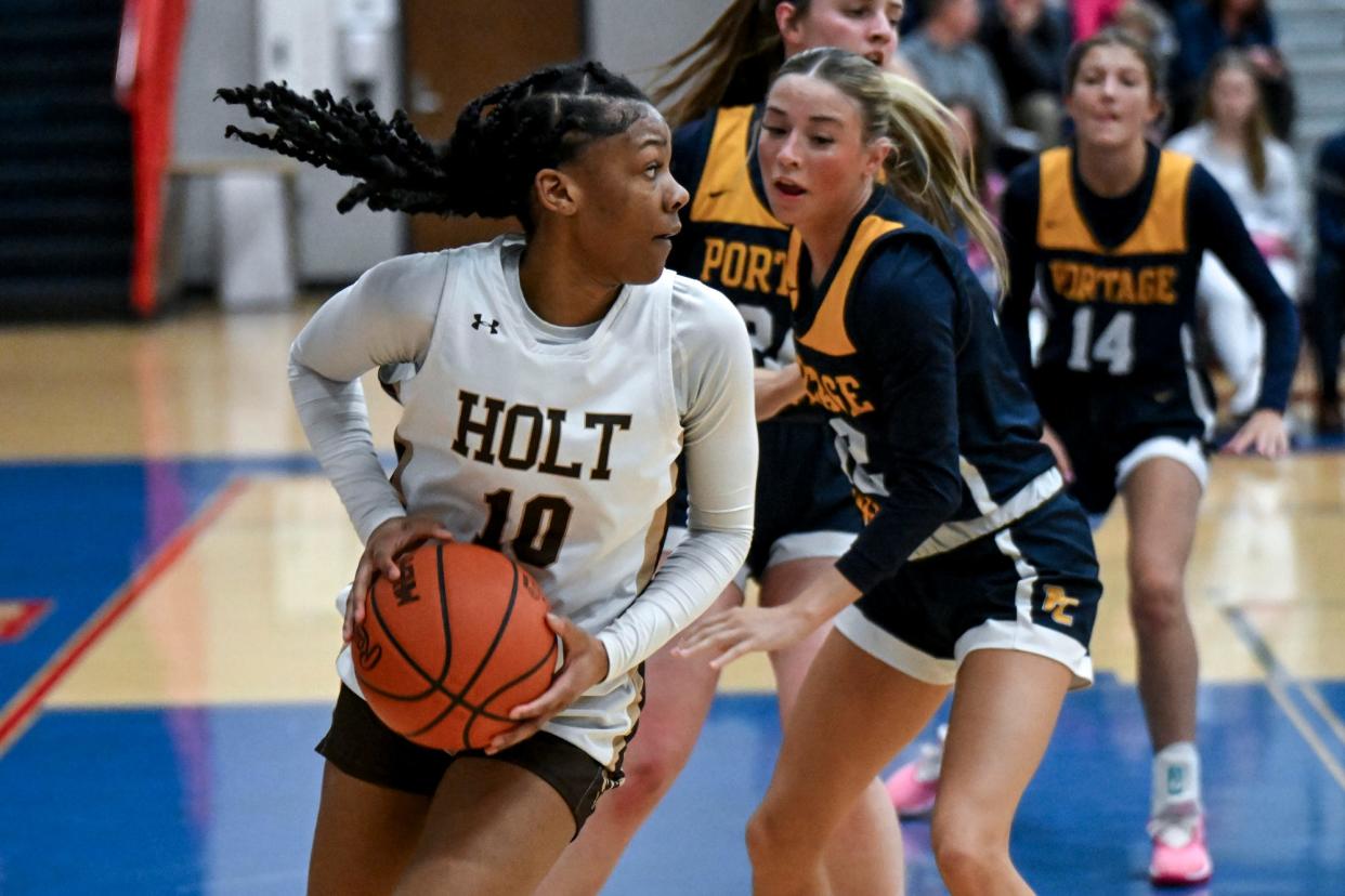 Holt's Rhema Dozier looks to pass against Portage Central'during the second quarter on Wednesday, March 13, 2024, at Mason High School.