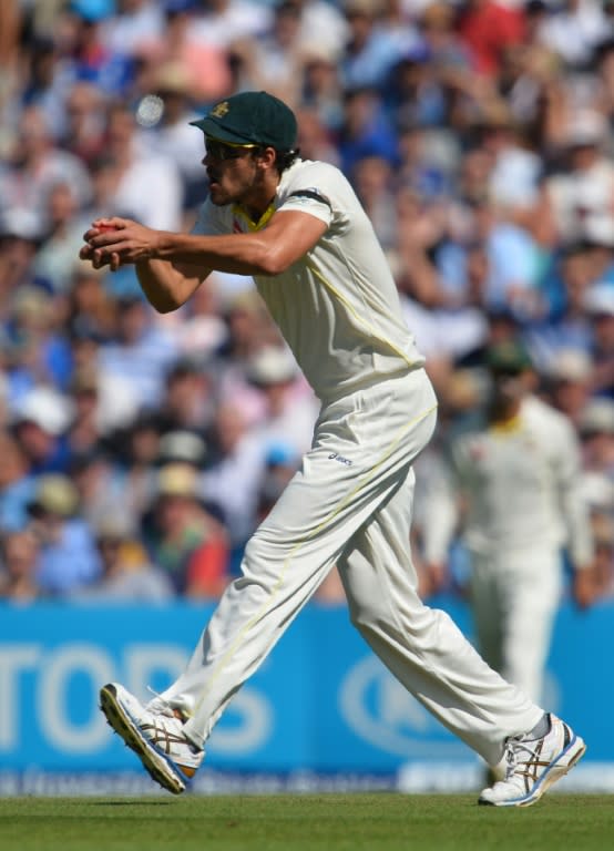 Australia's Mitchell Starc catches out England's Mark Wood on the third day of the fifth Ashes Test at the Oval on August 22, 2015