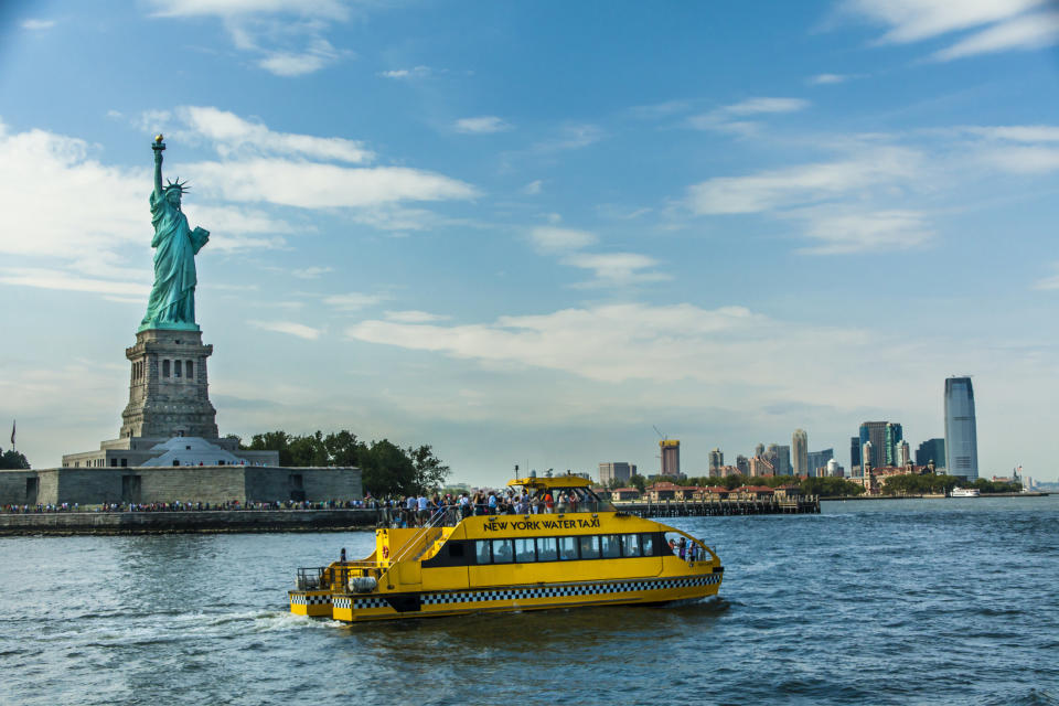 Statue of Liberty, a water taxi, and lower Manhattan
