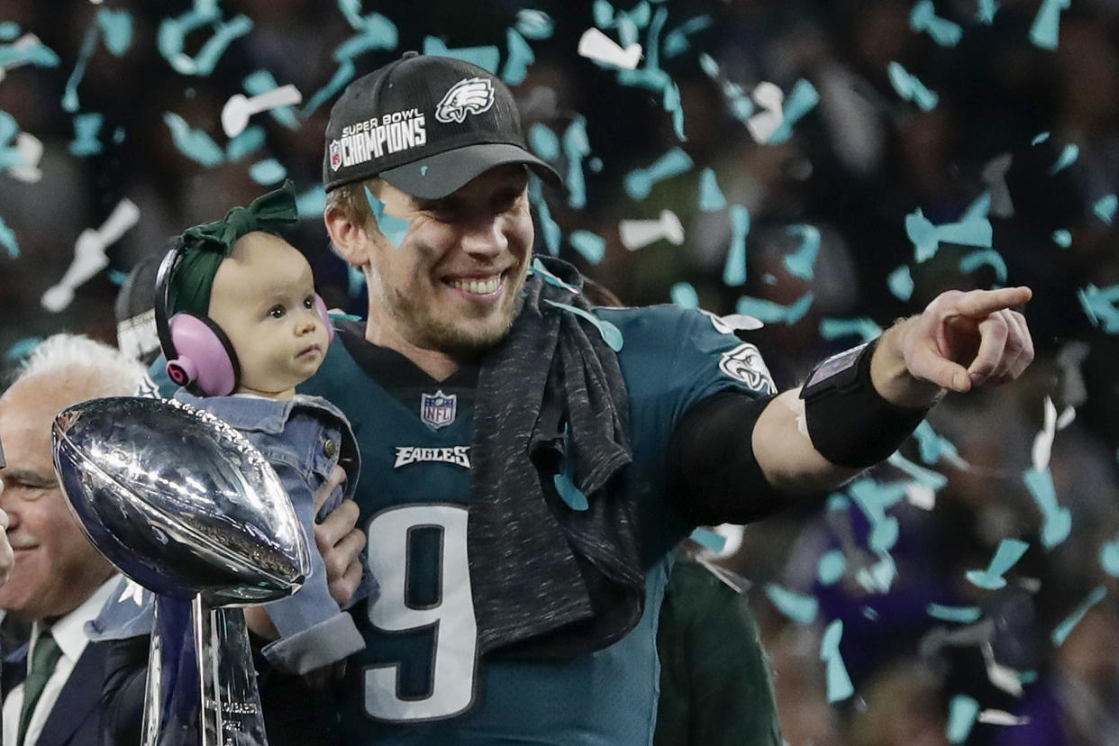 Philadelphia’s Nick Foles holds his daughter, Lily, after beating New England in Super Bowl LII, (AP)