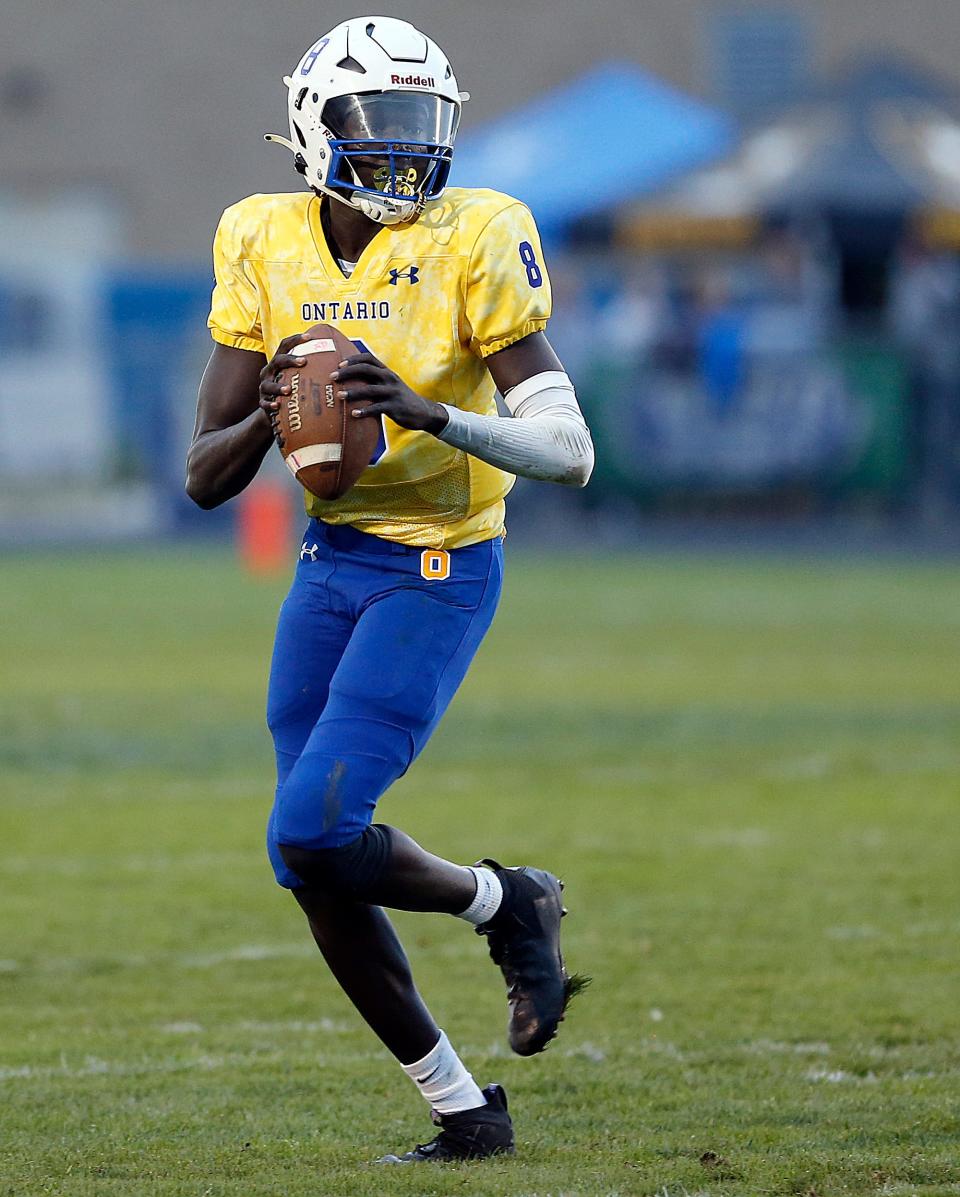 Ontario High School's Bodpegn Miller (8) rolls out looking to pass against River Valley High School during high school football action at Ontario High School, Friday, Sept. 8, 2023. TOM E. PUSKAR/MANSFIELD NEWS JOURNAL