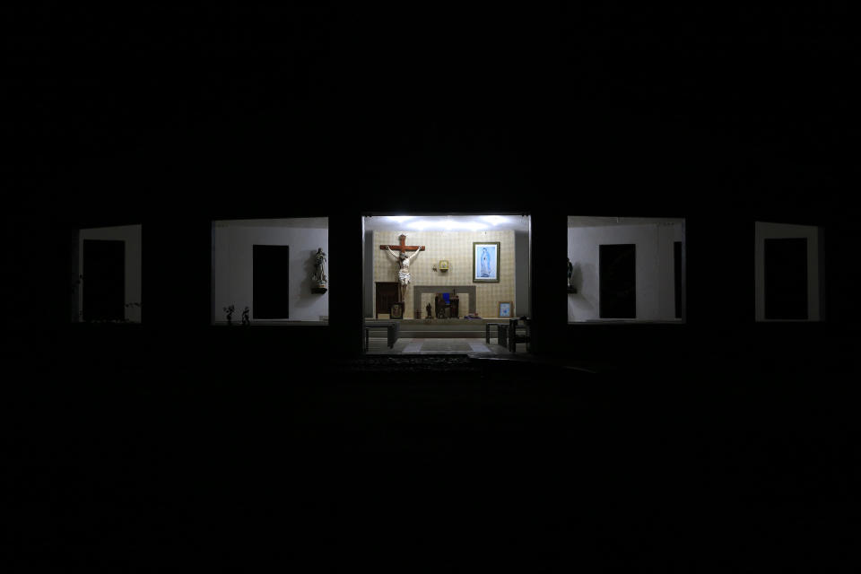 Lights illuminate an open-air Catholic church once used by prisoners at the now closed Morelos detention center during a media tour of the former Islas Marias penal colony located off Mexico's Pacific coast, before dawn Sunday, March 17, 2019. The colony was done in by high costs and by the increasing space available at mainland prisons as legal reforms reduced jail populations. (AP Photo/Rebecca Blackwell)