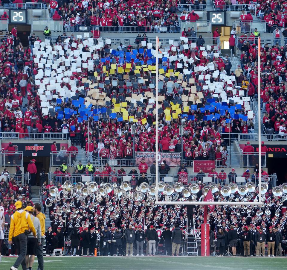 Nov 18, 2023; Columbus, OH, USA Students in the South Stands Block O section use cards to seemingly form Connor Stalions using binoculars to spy on Ohio State during the Ohio State vs. Minnesota football game Nov. 18, 2023 in Columbus, Ohio.