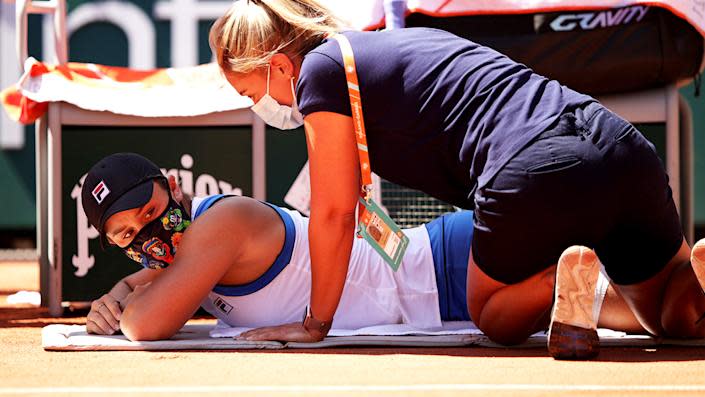 Seen here, Ash Barty receives medical treatment in her first round clash.