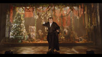 Tony Award-winner Jefferson Mays performs during a one-man high-tech “A Christmas Carol Live” that is being filmed for streaming this month at the empty 3,000-seat United Palace. The one-man show is an example of how many who work in the theater are increasingly defying COVID-19 by refusing to let it stop their art. (Courtesy of A Christmas Carol Live via AP)