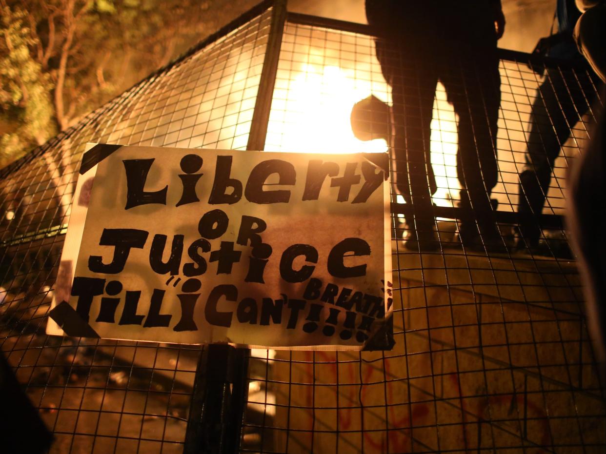 <p>Protesters gather outside the 3rd precinct police building while it burns on May 28, 2020 in Minneapolis, Minnesota.</p> (Getty Images)