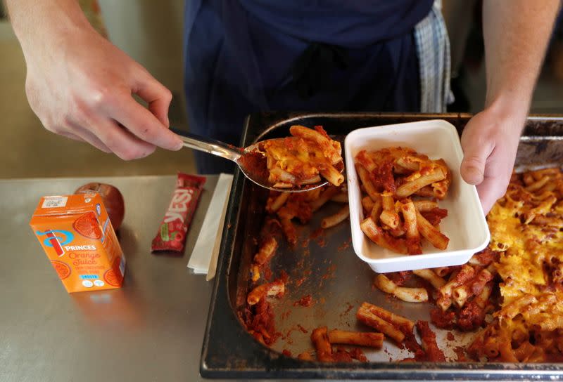 A chef from the St Giles Trust Brewbird cafe, prepares hot food packages for people in need of free school meals, in London