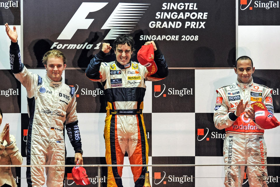 Spanish driver Fernando Alonso of Renault celebrates with third-placed British driver Lewis Hamilton of McLaren and second-placed Germany's Nico Rosberg of Williams on the podium following Alonso's victory in the Singapore Grand Prix Formula One final on Sept. 28, 2008. (Roslan Rahman / AFP via Getty Images file)