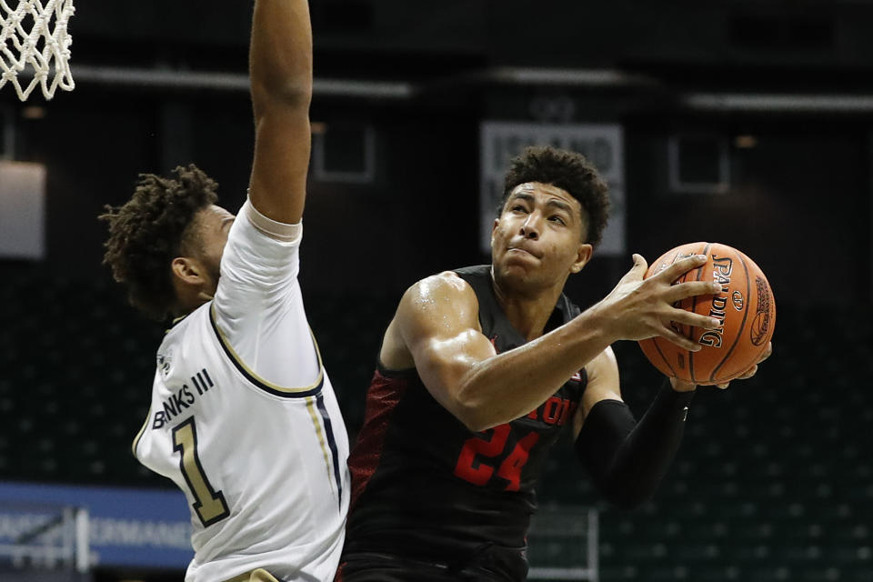 Houston guard Houston guard Quentin Grimes (24) is defended by Georgia Tech forward James Banks III (1) during the first half of an NCAA college basketball game Monday, Dec. 23, 2019, in Honolulu. (AP Photo/Marco Garcia)