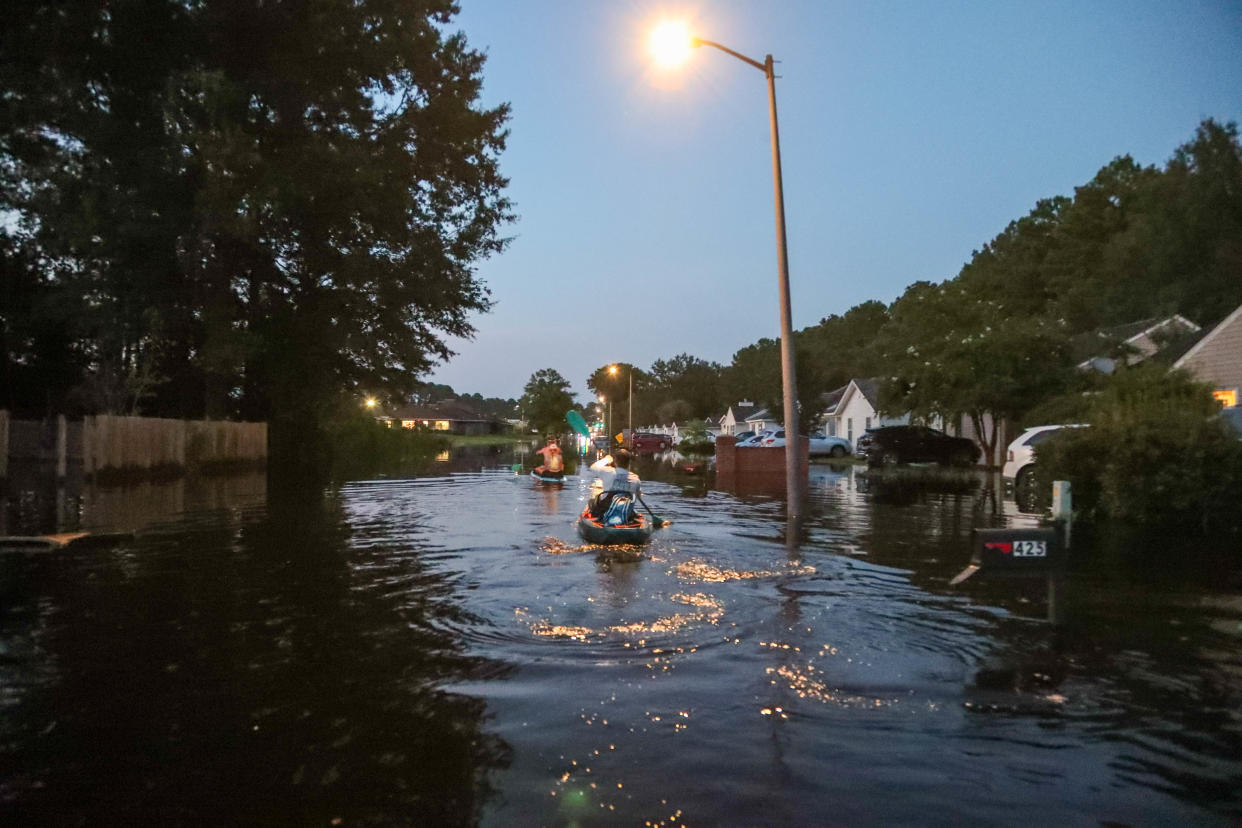 Volunteers paddle along Rushing Street on Saturday, August 10, 2024 as rising waters from the Ogeechee River brought major flooding to the Rushing Station neighborhood in Richmond Hill, Georgia.