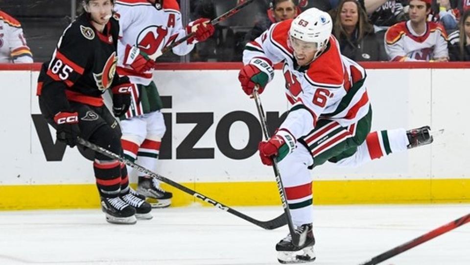 Mar 25, 2023;  Newark, New Jersey, USA;  New Jersey Devils left wing Jesper Bratt (63) attempts a shot against the Ottawa Senators during the second period at the Prudential Center.