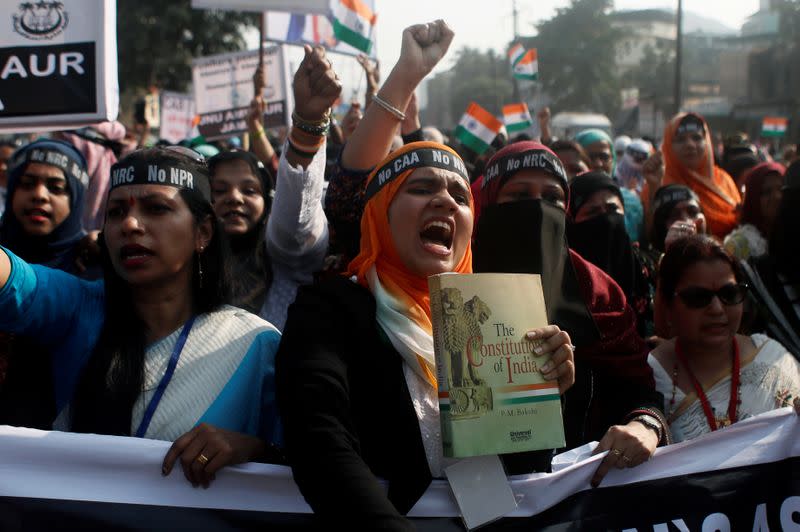 Demonstrators shout slogans during a protest against a new citizenship law on the outskirts of Mumbai