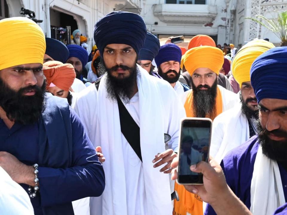 Amritpal Singh, centre, is seen at the Golden Temple in Amritsar, the capital of India's northwestern Punjab state, on March 3. Indian authorities have blocked communications in Punjab as they search for the preacher who is accused of fomenting unrest and violence. (Narindra Nanu/AFP via Getty Images - image credit)