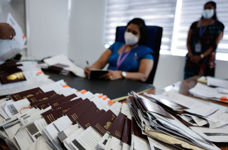 Sri Lankans gather outside the Immigration and Emigration Department to get their passports to leave the country amid the country's economic crisis