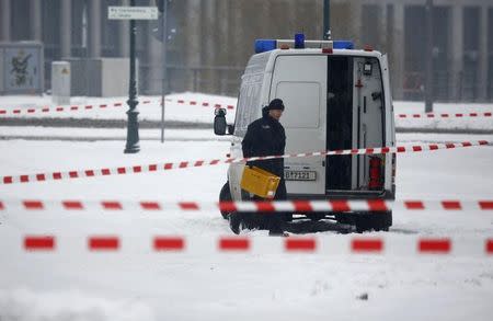 Police removes suspicious yellow postal crates near the chancellory in Berlin, Germany on January 6, 2016. REUTERS/Hannibal Hanschke