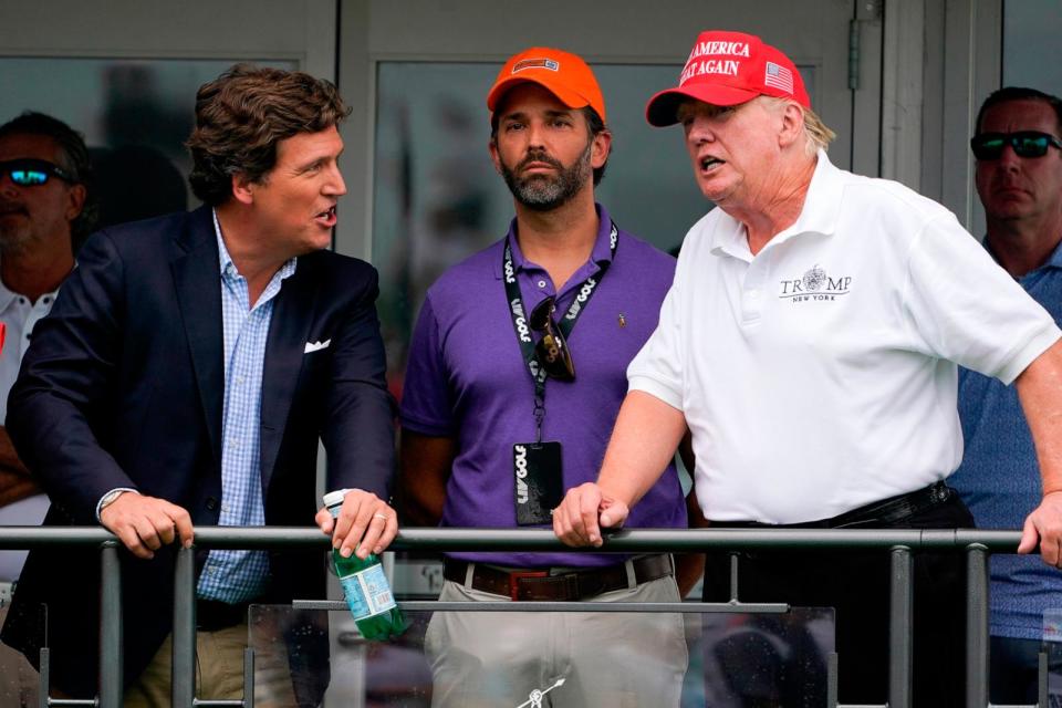 PHOTO: In this July 31, 2022, file photo, former President Donald Trump talks with Donald Trump Jr., and Tucker Carlson at the 16th tee during the final round of the Bedminster Invitational LIV Golf tournament in Bedminster, N.J. (Seth Wenig/AP, FILE)