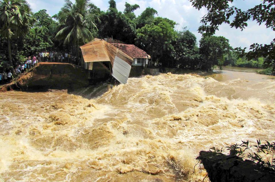 Indians stand and watch floodwaters in Panskura, near the East Midnapore district in the eastern Indian state of West Bengal, India, Saturday, Aug. 24, 2013. India's monsoon season, which runs from June through September, bring rains that are vital to agriculture but also cause floods and landslides. (AP)