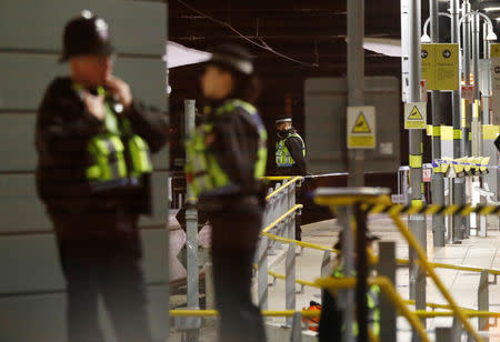 Police officers stand at the end of a tram platform following a stabbing at Victoria Station in Manchester, Britain, January 1, 2019. REUTERS/Phil Noble