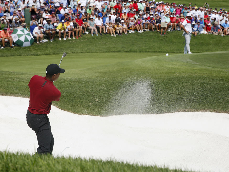 Tiger Woods hits out of a bunker on the fifth hole during the final round of the PGA Championship golf tournament at Bellerive Country Club, Sunday, Aug. 12, 2018, in St. Louis. (AP Photo/Brynn Anderson)