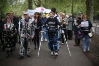 LONDON, ENGLAND - MAY 08: Claire Lomas (C) walks the last mile of the London Marathon on May 8, 2012 in London, England. Ms Lomas, who is paralysed from the waist down after a riding accident in 2007, has taken 16 days to complete the 26.2 mile route. Starting out with 36,000 other runners she has averaged 2 miles a day with the help of a bionic ReWalk suit. (Photo by Peter Macdiarmid/Getty Images)