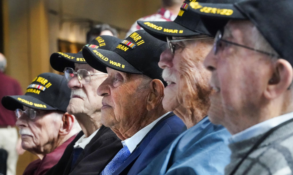 World War II veteran Joseph Eskenazi, center, who at 104 years and 11 months old is the oldest living veteran to survive the attack on Pearl Harbor, sits with fellow Pearl Harbor veterans, at an event celebrating his upcoming 105th birthday at the National World War II Museum in New Orleans, Wednesday, Jan. 11, 2023. Left to right are Wallace Johnson, Gordon Wilson, Eskenazi, Billy Hall and Tony DiLisa. (AP Photo/Gerald Herbert)
