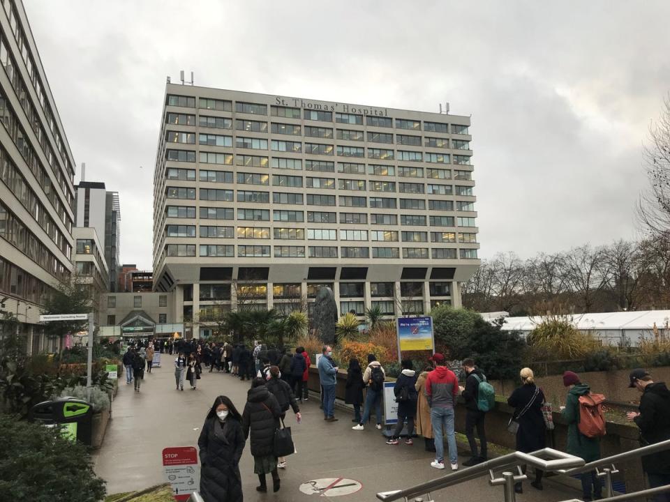 People queuing for booster jabs at St Thomas Hospital, London. Everyone over 18 in England will be offered booster jabs from this week, the PM said on Sunday night, as he declared an “Omicron emergency” (PA)