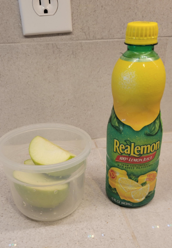 lemon juice next to a carton of apples