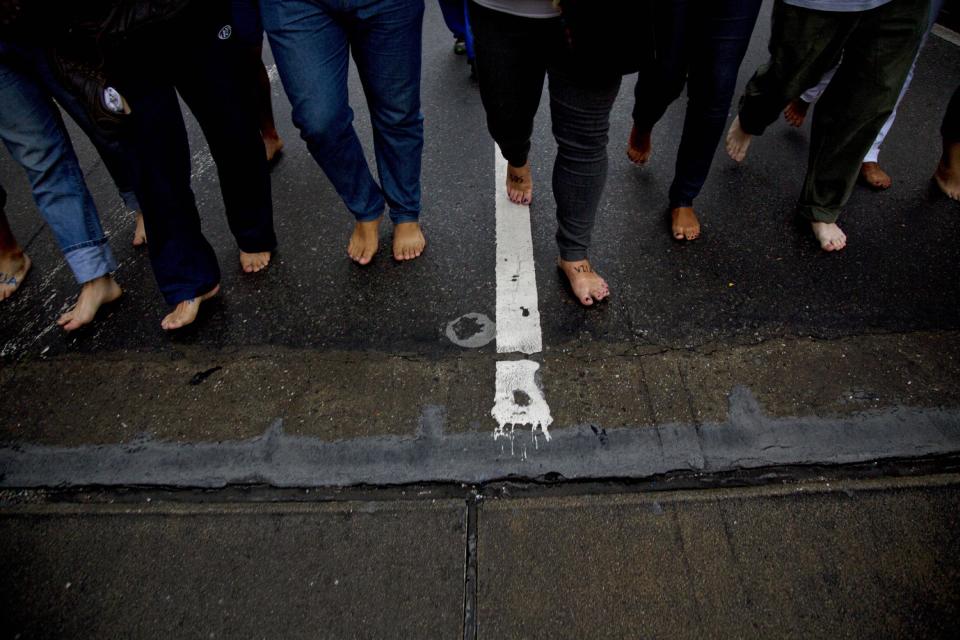 Anti-government protesters march without shoes to a plaza in Caracas, Venezuela, Wednesday, April 16, 2014. Students said the barefoot march during Holy Week was a symbolic paying of penance for Venezuela's political unrest, high crime and inflation. (AP Photo/Ramon Espinosa)