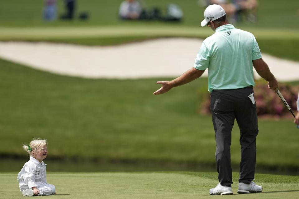 Ryan Fox, of New Zealand, gestures towards his daughter Isobel on the fourth hole during the par-3 contest at the Masters golf tournament at Augusta National Golf Club Wednesday, April 10, 2024, in Augusta, Ga. (AP Photo/George Walker IV)
