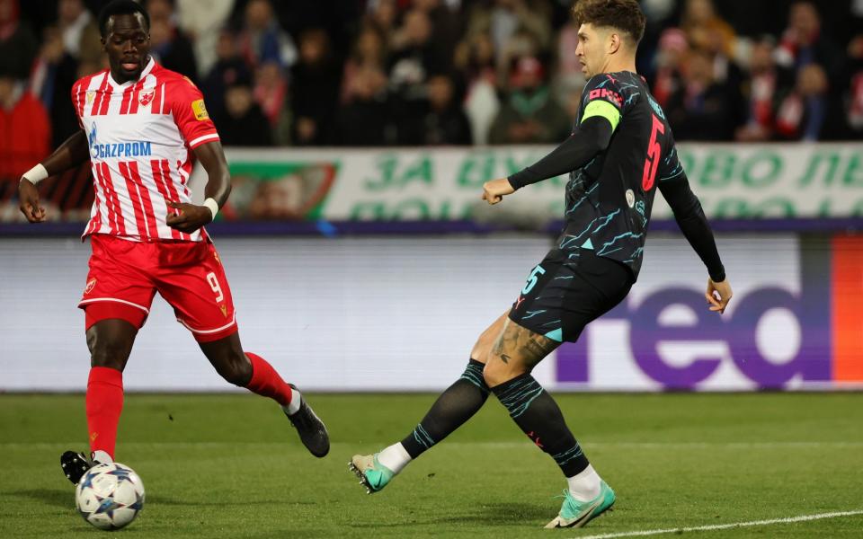 Cherif Ndiaye of FK Crvena zvezda challenges John Stones of Manchester City during the UEFA Champions League match between FK Crvena zvezda and Manchester City at Stadion Rajko MitiÄ‡ on December 13, 2023 in Belgrade, Serbia