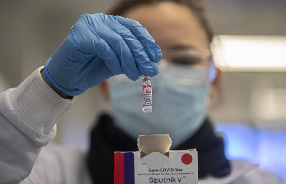 FILE - A Uniao Quimica pharmaceutical employee holds a vial at the company's control center for the Russian Sputnik V COVID-19 vaccine in Guarulhos in the greater Sao Paulo area of Brazil, May 20, 2021. On Monday, the U.S. will implement a new air travel policy to allow in foreign citizens who have completed a course of a vaccine approved by the Food and Drug Administration or the World Health Organization. That leaves people in Mexico, Hungary, Russia and elsewhere who received the non-approved Russian Sputnik V vaccine or the China-produced CanSino vaccine ineligible to board U.S.-bound flights. (AP Photo/Andre Penner, File)