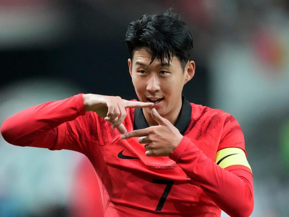 Son Heung-min forms a square with his fingers during a South Korea soccer match