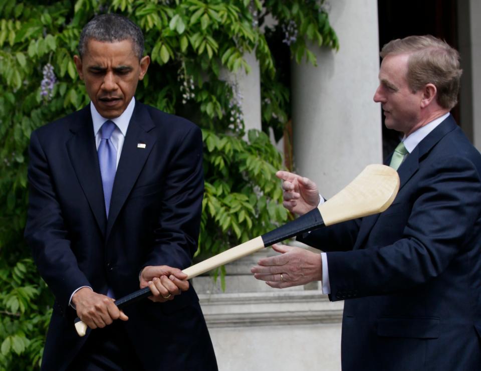 President Barack Obama, left, is given a lesson in how to hold a hurling stick by Ireland's Taoiseach Enda Kenny, at Farmleigh House after after a visit in Dublin, Ireland, Monday, May 23, 2011. 