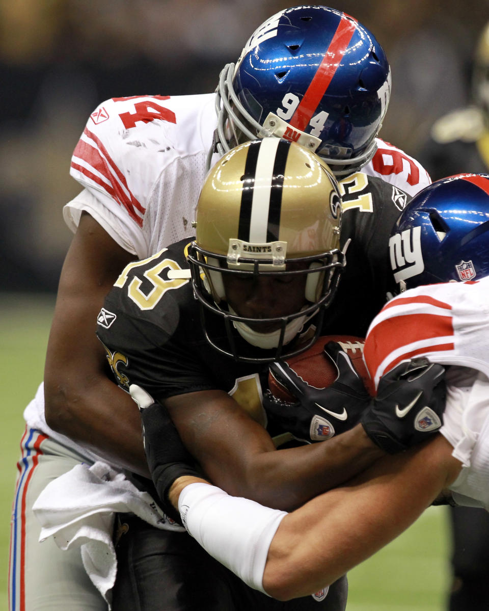 NEW ORLEANS, LA - NOVEMBER 28: Wide receiver Devery Henderson #19 of the New Orleans Saints is tackled by Mathias Kiwanuka #94 and linebacker Mark Herzlich #58 of the New York Giants in the second quarter at Mercedes-Benz Superdome on November 28, 2011 in New Orleans, Louisiana. (Photo by Ronald Martinez/Getty Images)