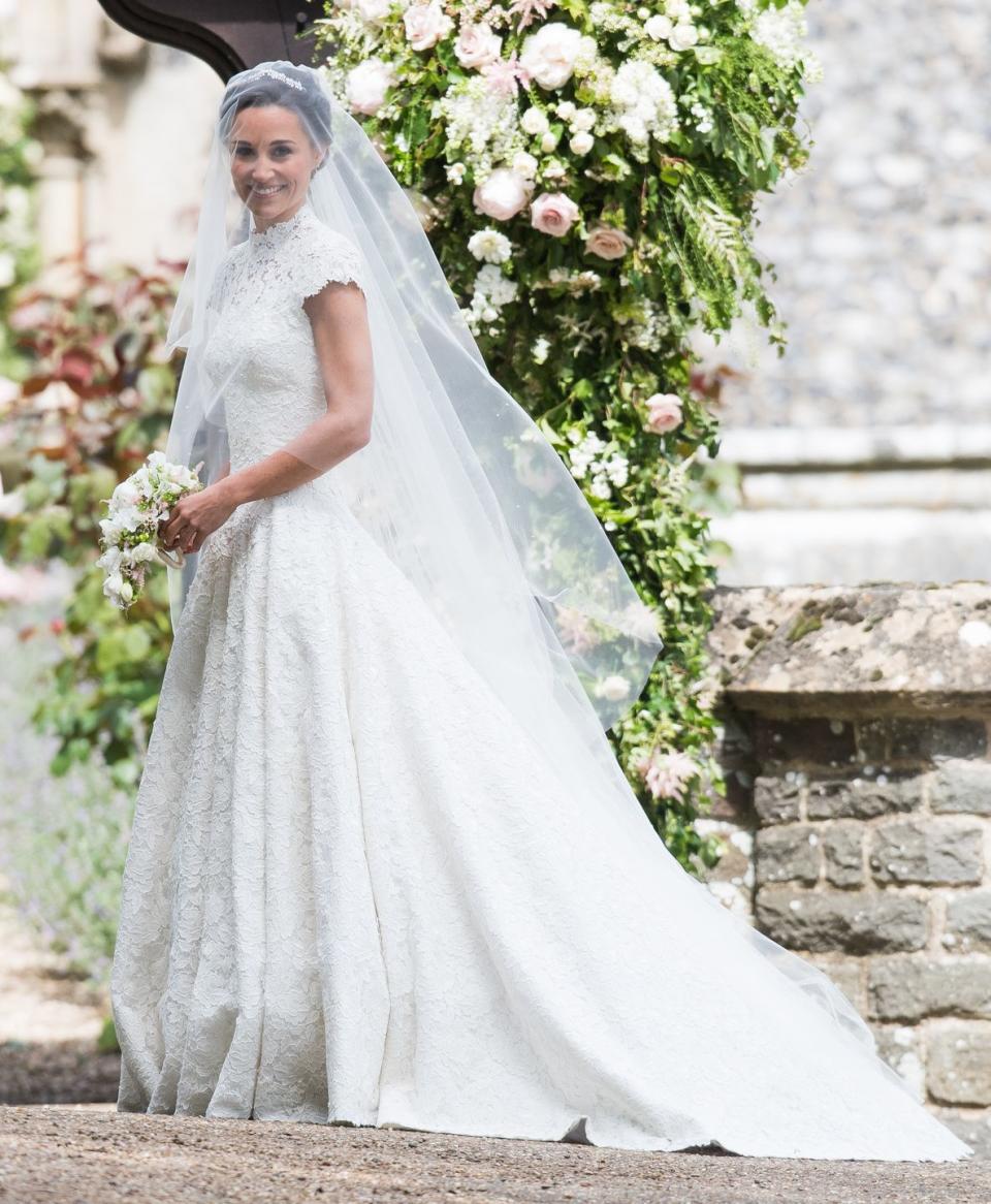 <p>Pippa Middleton drew a big audience on the day of her nuptials, with a lot of speculation about who would get to design the dress. British designer Giles Deacon held the baton on the day, creating this custom lace gown that wasn't totally dissimilar to her big sister Kate Middleton's dress. </p>