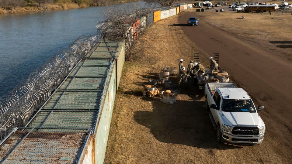 In an aerial view, Texas National Guard soldiers load excess concertina wire onto a trailer at Shelby Park on January 26, 2024 in Eagle Pass, Texas. - Michael Gonzalez/Getty Images