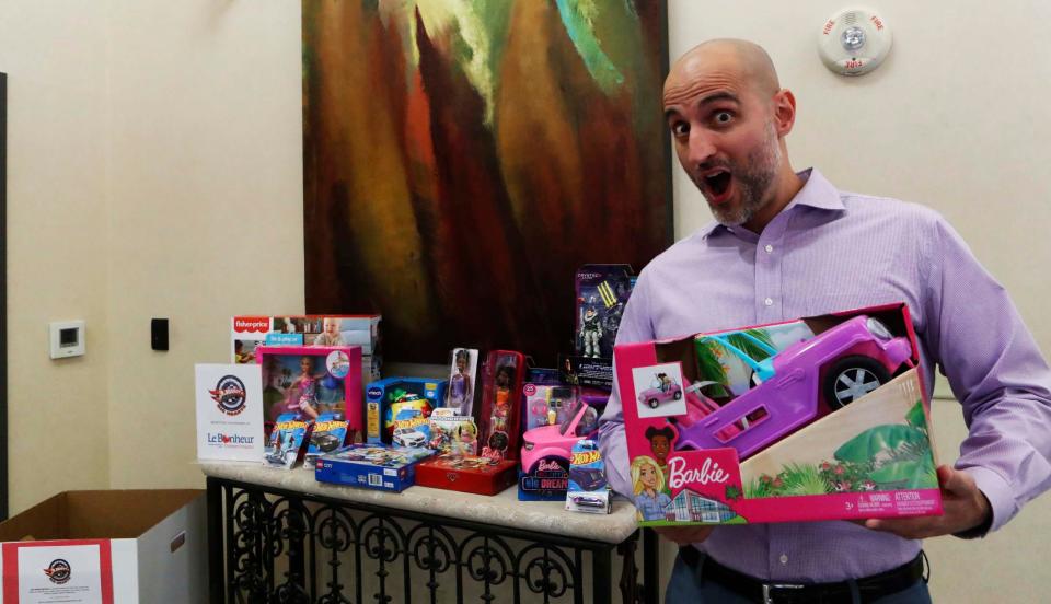 Shaun Smith, a financial specialist at Pinnacle Financial Partners, shows his excitement about the donations he has received so far for his Little Wheels Big Hearts of Tennessee toy drive for Le Bonheur Children’s Research Hospital at 9057 Poplar Avenue on Wednesday, Nov. 15, 2023 in Germantown, Tenn.