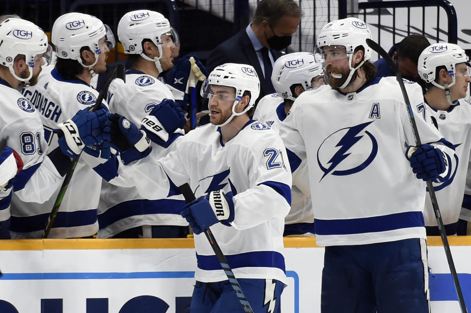 Tampa Bay Lightning center Brayden Point (21) is congratulated after scoring a goal against the Nashville Predators during the second period of an NHL hockey game Tuesday, April 13, 2021, in Nashville, Tenn. (AP Photo/Mark Zaleski)