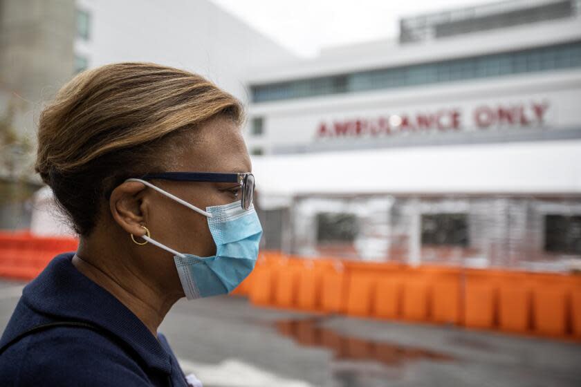 Los Angeles, CA - January 02: Dr. Elaine Batchlor, chief executive of MLK Community Healthcare walks around the exterior of the Emergency Department at MLK Community Hospital on Monday, Jan. 2, 2023, in Los Angeles, CA. It has only 29 rooms for patients, so the MLK emergency department has relied on "unconventional clinic space," said Dr. Elaine Batchlor, chief executive of MLK Community Healthcare. Ambulance bays now hold tents for assessing and treating patients. (Francine Orr / Los Angeles Times)