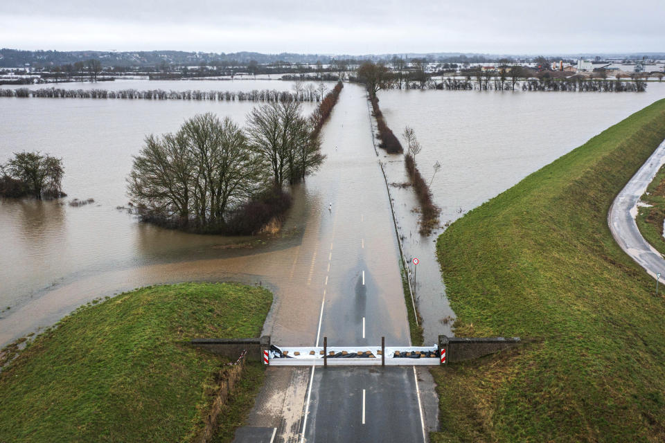 A flooded road is seen in Thedinghausen, Germany, Friday, Jan. 5, 2024. (Sina Schuldt/dpa via AP)