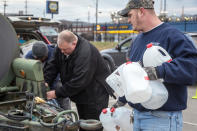 Employees of the South Charleston Public Works Department assisted the residents in obtaining cases of water and filling the containers they brought with them Sunday, Jan. 12, 2014 after a chemical spill Thursday in the Elk River that has contaminated the public water supply in nine counties. Frustration is mounting for many of the 300,000 West Virginia residents who've gone three days without clean tap water.The West Virginia National Guard was sent to help distribute bottled water. (AP Photo Michael Switzer)