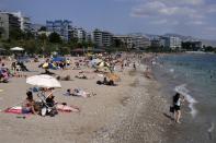 Greeks enjoy a day out on the beach in Athens