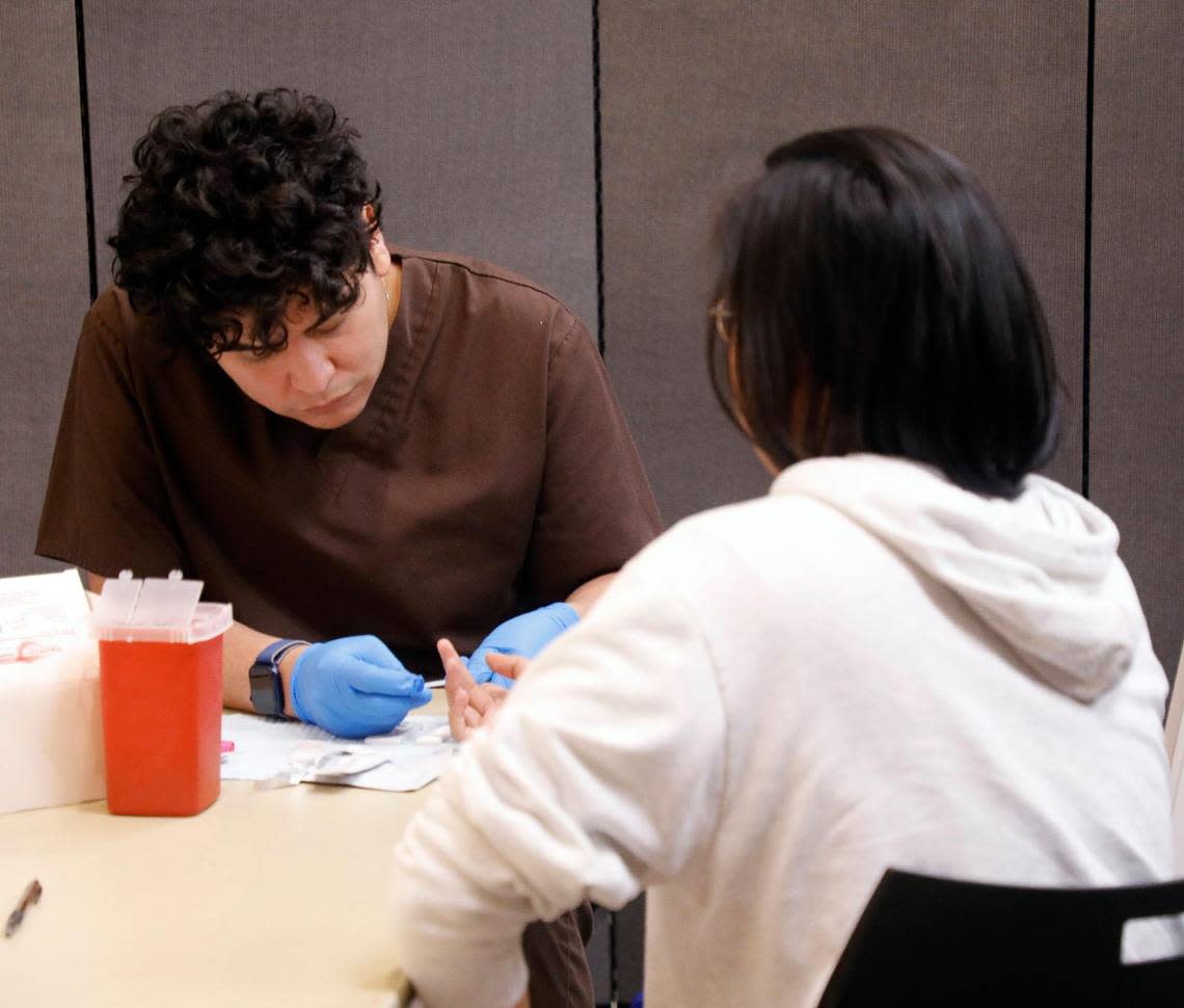 Risk Reduction Specialist, Francisco Facundo, with the Aids Outreach Center draws blood for STI testing at Tarrant County College NE in Hurst, Texas, Tuesday May 16, 2023. One of two programs offered through the college The Aids Outreach Center sees over 25 clients each offering. (Special to the Star-Telegram Bob Booth)