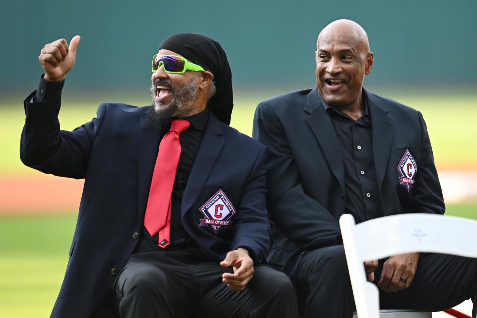 Former Cleveland players Manny Ramirez and Sandy Alomar Jr., right, acknowledge the crowd during the Guardians Hall of Fame ceremony for CC Sabathia before Saturday's game between the Guardians and the Baltimore Orioles in Cleveland.