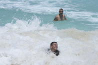 Tourists swim in the ocean ahead of Hurricane Beryl's expected arrival in Cancun, Mexico, Wednesday, July 3, 2024. (AP Photo/Fernando Llano)