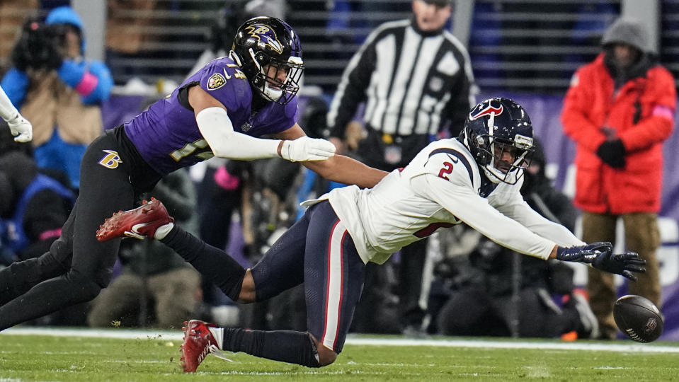 Houston Texans wide receiver Robert Woods (2) tries to make the catch against Baltimore Ravens safety Kyle Hamilton (14) during the first half of an NFL football AFC divisional playoff game, Saturday, Jan. 20, 2024, in Baltimore. (AP Photo/Julio Cortez)