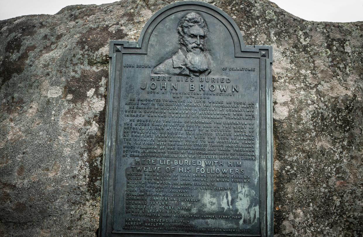 A plaque marks John Brown's gravesite at John Brown Farm historic site in North Elba, New York. A militant abolitionist, Brown attacked a federal armory on October 16, 1859, in Harpers Ferry in what was then Virginia in hopes of sparking an armed slave uprising. 