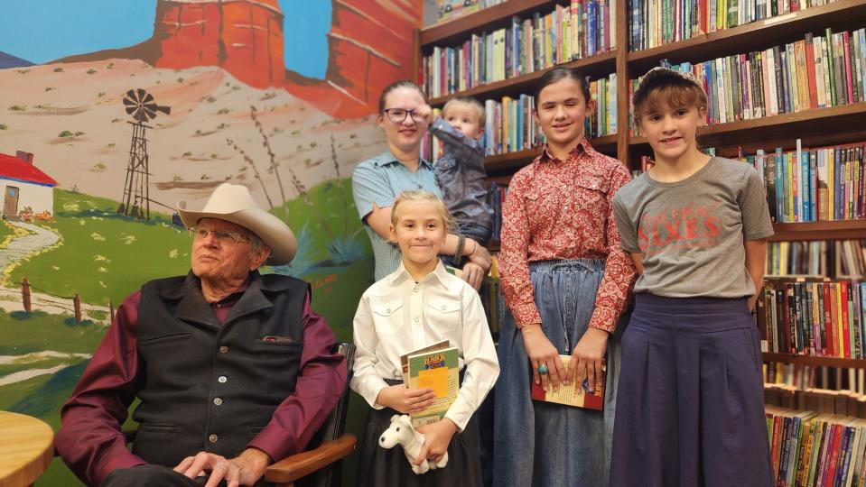 The Bradbury family enjoys their meeting Thursday with John Erickson, author of the popular "Hank the Cowdog" book series, at the Burrowing Owl bookstore in Amarillo.